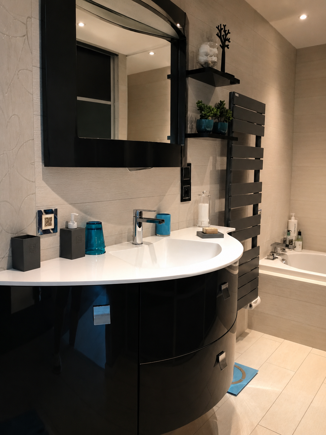 Contemporary en-suite bathroom with sculptural black vanity